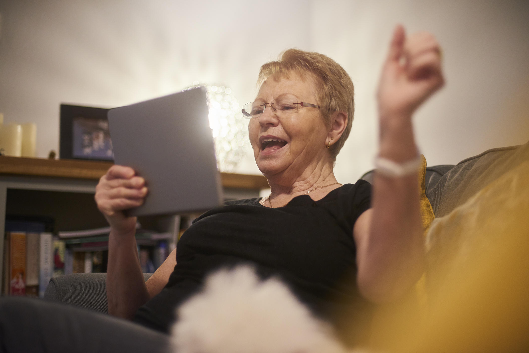 Senior woman punches the air in celebration